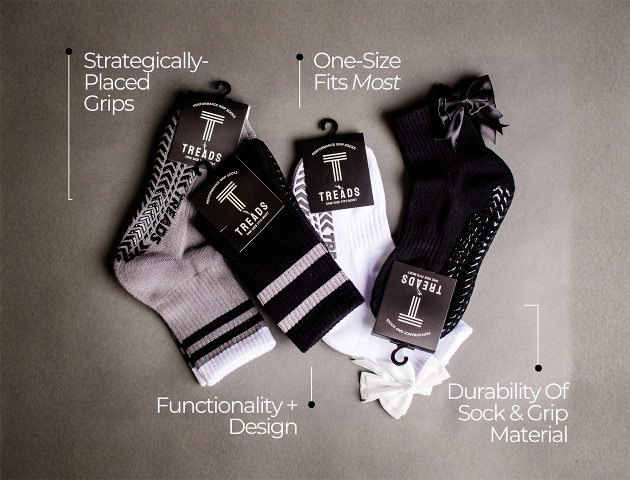 Flat lay of Treads performance grip socks in multiple colors with packaging, highlighting features like strategically placed grips, one size fits most, durability, and functional design.